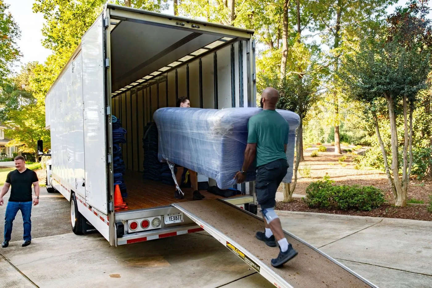 Movers loading a moving truck outside a home